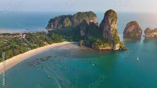 Railay Beach, Krabi, Thailand Beautiful beach and sea of Thailand at sunset Aerial view of Railay Beach, tourists and long-tail boats, lush rainforest and emerald sea	