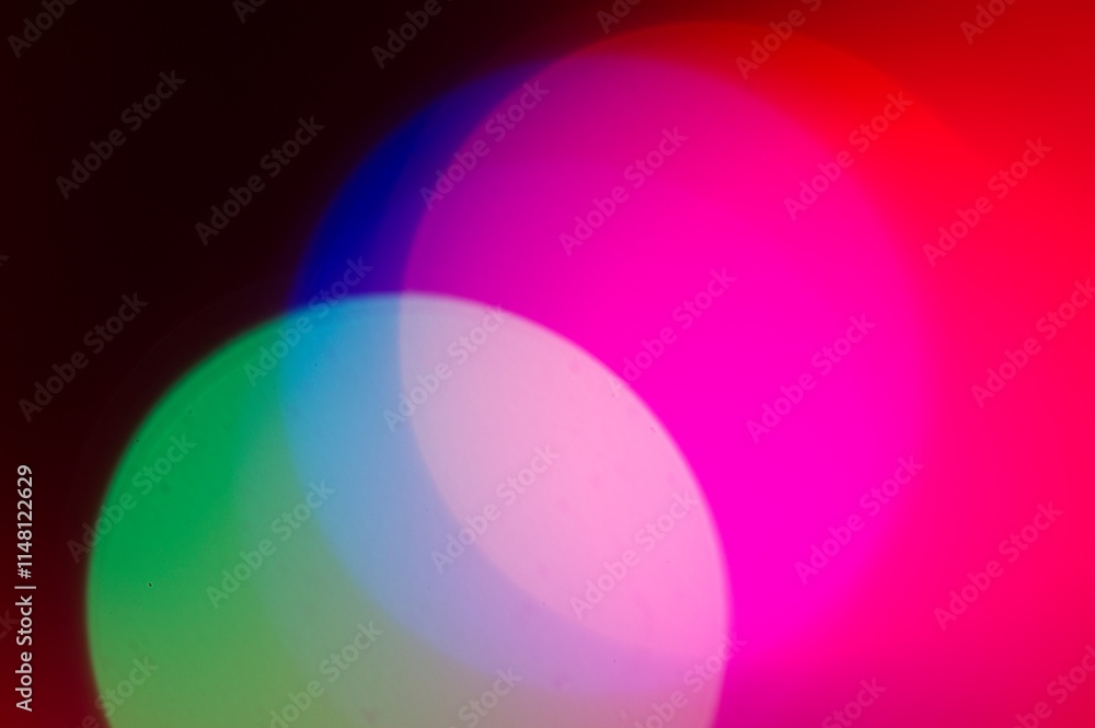 Circles of light converging in multiple colors in an abstract background Circles of light converging in multiple colors in an abstract background