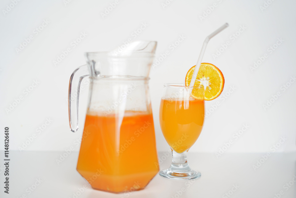 Refreshing Orange Juice in Glass Jug and Tumbler. on white background. Premium Stock Image Refreshing Orange Juice in Glass Jug and Tumbler. on white background. Premium Stock Image