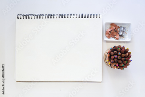Minimalist Creative Workspace with Art Supplies, colored pencils and blank spiral sketchpad