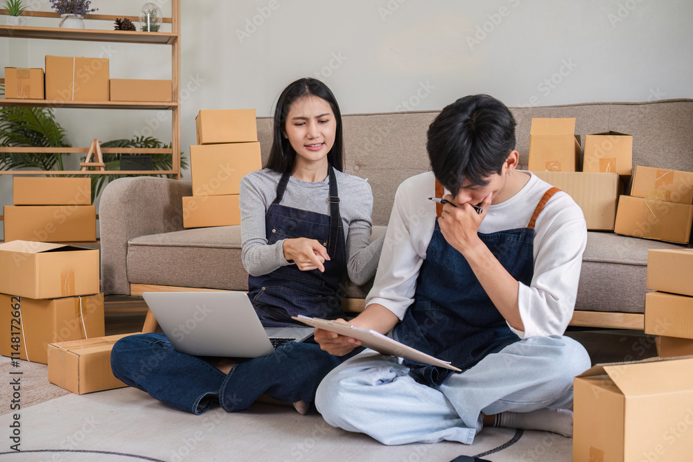 Stressed Couple Managing Online Business from Home with Wrong Order Issues Surrounded by Cardboard Boxes Stressed Couple Managing Online Business from Home with Wrong Order Issues Surrounded by Cardboard Boxes