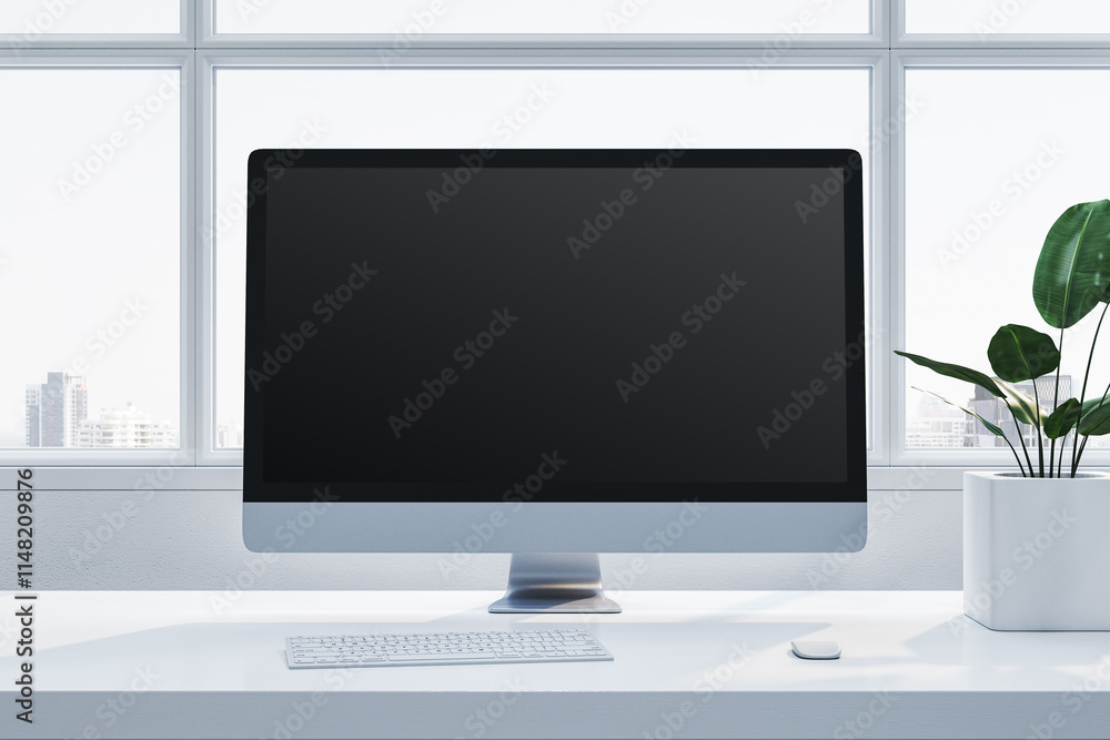 Fototapeta premium Modern desktop computer on a white desk near a plant, with large windows in the background, in a bright office setting. 3D Rendering