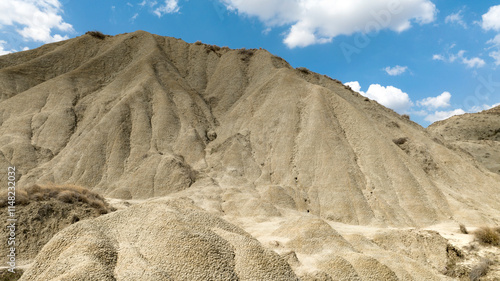 Aerial view of the Calanchi near Pisticci, in the province of Matera, Basilicata, Italy. Badlands are a type of dry terrain where sedimentary rocks and clay-rich soils have been eroded away.