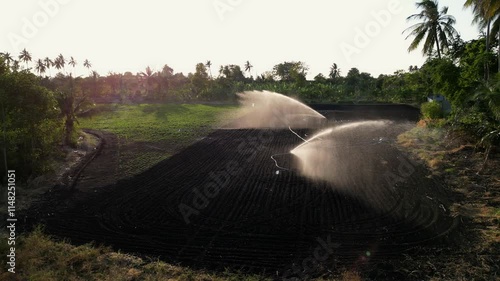 Aerial view of agricultural sprinkler Irrigation system on green agricultural land