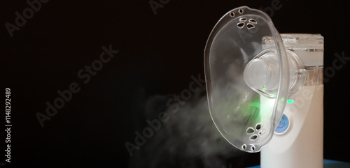 Portable nebulizer producing vapor in a dark setting for respiratory therapy use