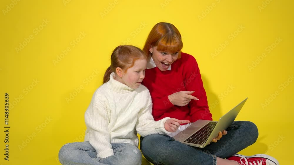 Excitement fills the room as a girl and her friend explore online wonders together Excitement fills the room as a girl and her friend explore online wonders together