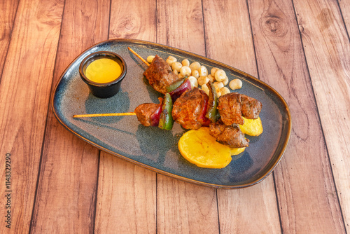 A pincho moruno is a skewer made with diced meat, usually chicken or pork, marinated in paprika and garlic, generally spicy depending on the type of paprika used in the marinade photo