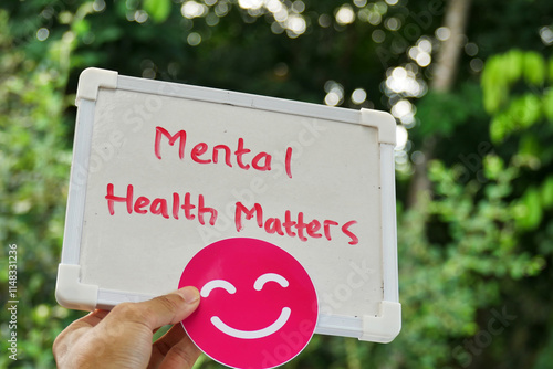 Mental Health matters handwritten on the board and smiley face stickers