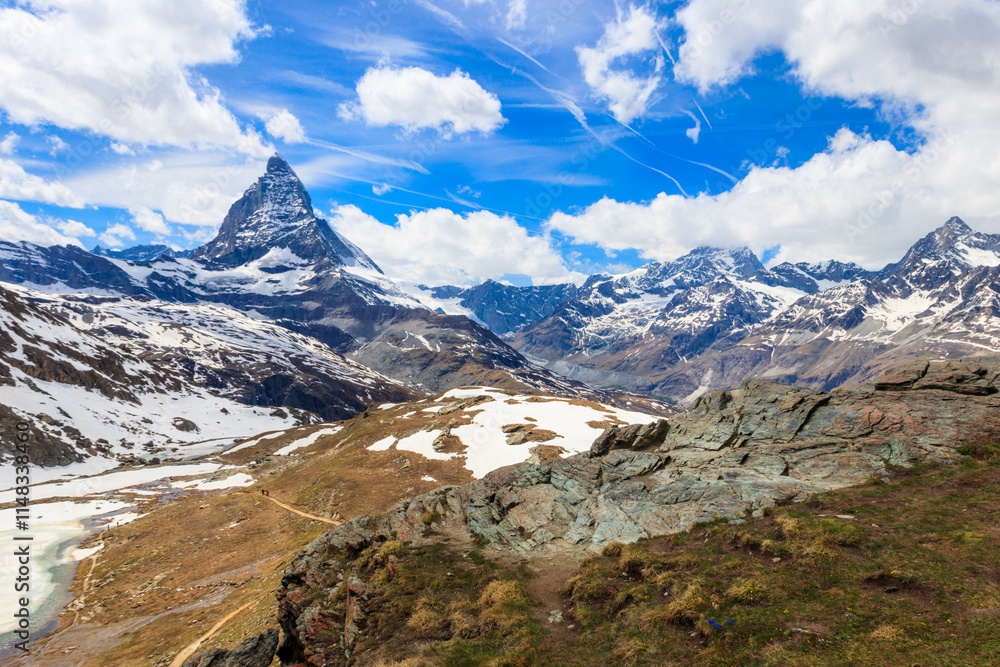 Fototapeta premium Scenic view on snowy Matterhorn mountain peak in sunny day with blue sky in Switzerland. Beautiful nature background of Swiss Alps covered with snow. Famous travel destination