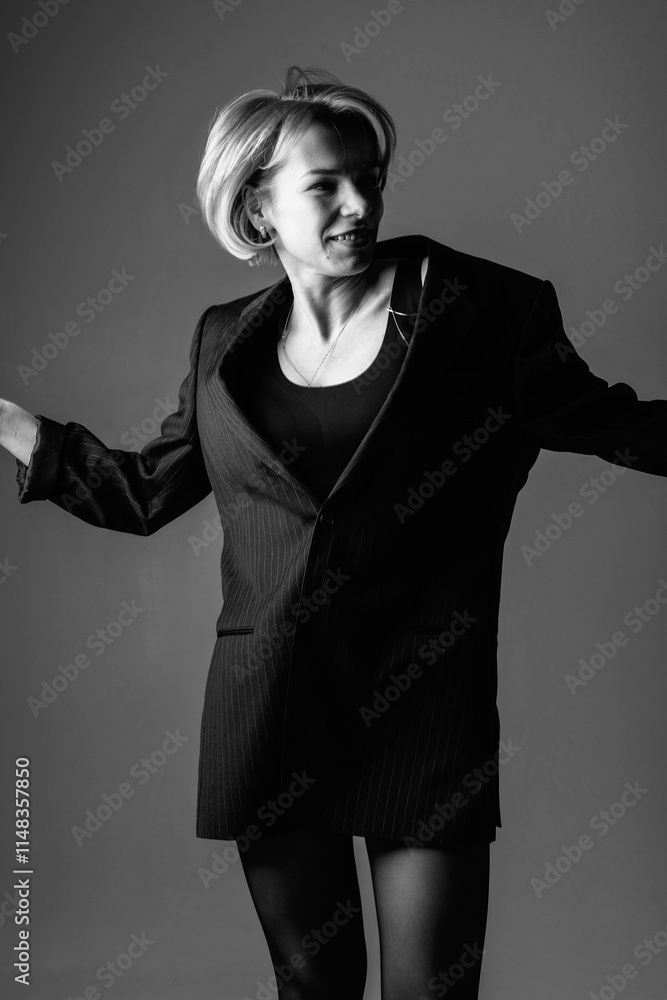 Fototapeta premium Portrait of a young beautiful girl in the studio. Black and white photo.