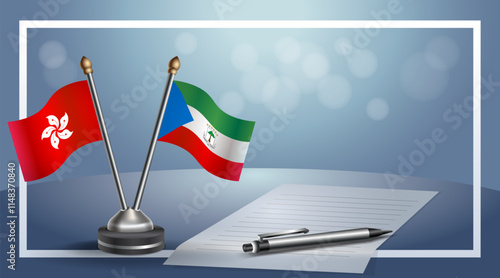 Hong Kong and Equatorial Guinea National flags on small table with bokeh background, cooperative relationship