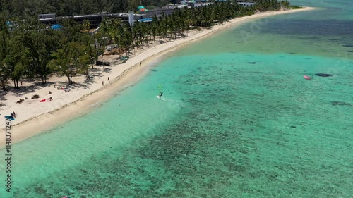Kitesurfers, windsurfers on the Le Morne beach, famous aquatic sports spot in Mauritius island. Kite surfing in the clear waters of the Indian Ocean in Le Morne beach, Mauritius.