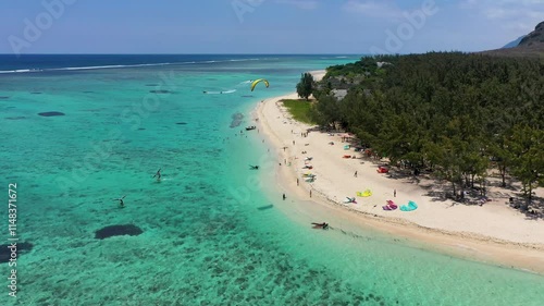 Kitesurfers, windsurfers on the Le Morne beach, famous aquatic sports spot in Mauritius island. Kite surfing in the clear waters of the Indian Ocean in Le Morne beach, Mauritius.