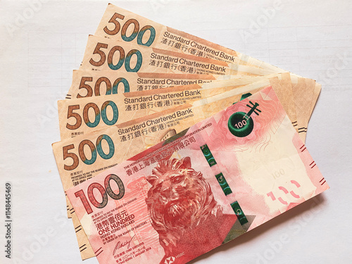 Photography several 100 and 500 hongkong dollar banknotes arranged in a playing card pattern