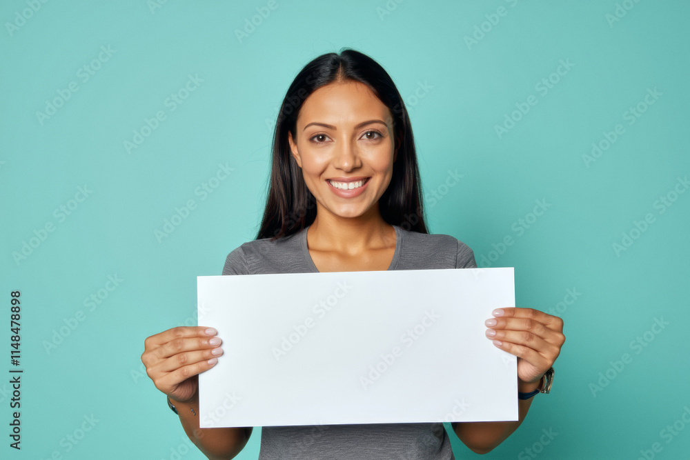 An advertisement studio template portrait photo of a person: a woman with a bright smile on her face, holding a blank white sign in her hands against a blue background. An advertisement studio template portrait photo of a person: a woman with a bright smile on her face, holding a blank white sign in her hands against a blue background.