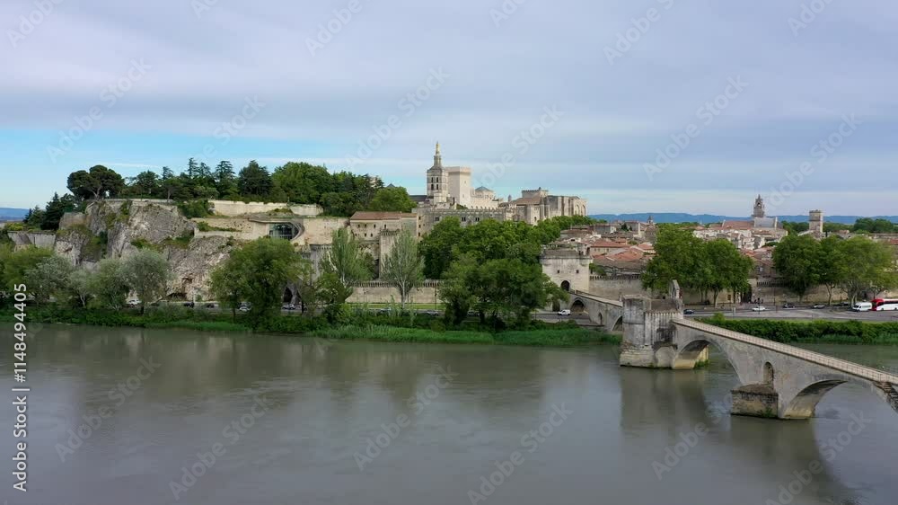 Beautiful view of Avignon with famous bridge Saint-Benezet, medieval architecture along the Rhone River in Avignon, France. The Pont Saint Benezet and the Papal palace in Avignon, South France. Beautiful view of Avignon with famous bridge Saint-Benezet, medieval architecture along the Rhone River in Avignon, France. The Pont Saint Benezet and the Papal palace in Avignon, South France.