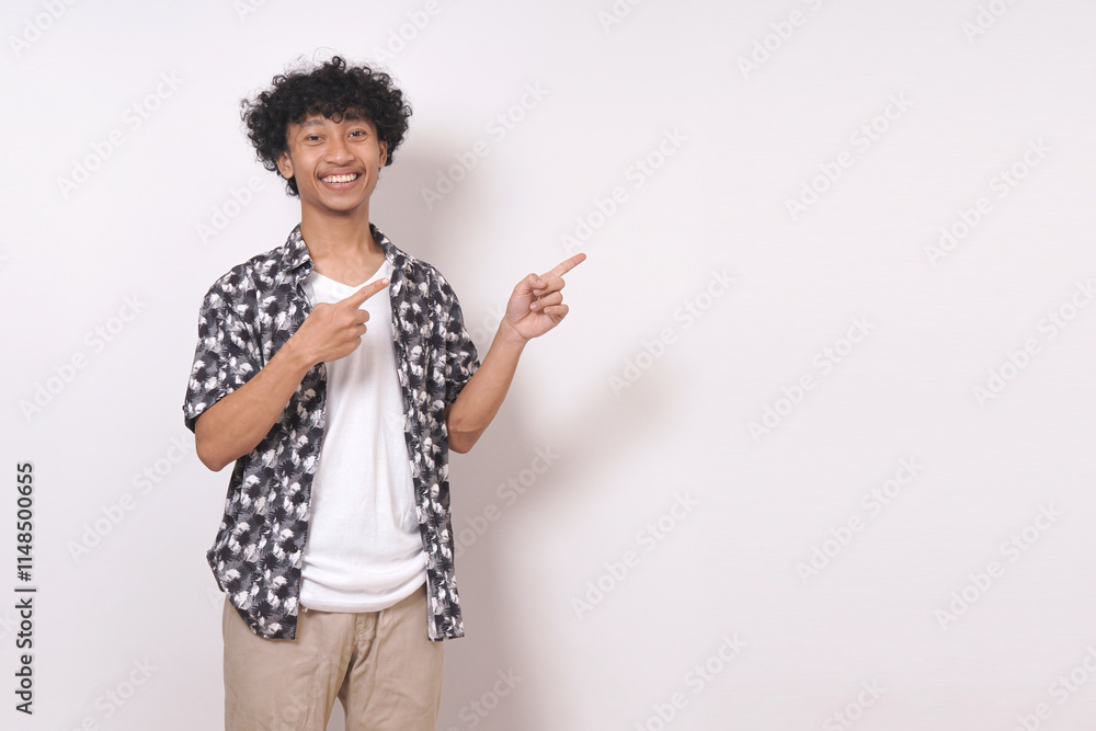 young travel man standing and pointing to side with smile isolated on white background. young travel man standing and pointing to side with smile isolated on white background.