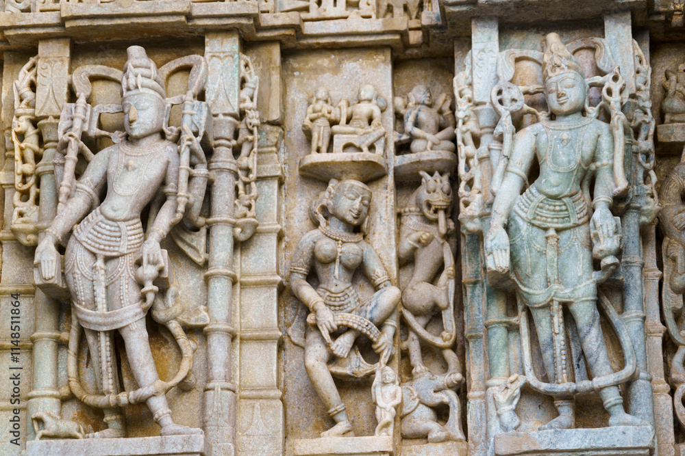 India. Rajasthan state. Ranakpur. Chaumukha Temple, also called the Ranakpur Temple dedicated to Lord Adinatha. Sculpture en bas-relief at Surya Narayan temple India. Rajasthan state. Ranakpur. Chaumukha Temple, also called the Ranakpur Temple dedicated to Lord Adinatha. Sculpture en bas-relief at Surya Narayan temple