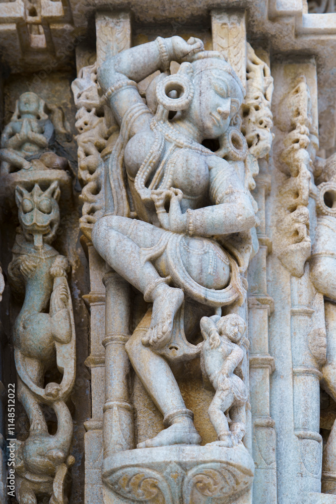 India. Rajasthan state. Ranakpur. Chaumukha Temple, also called the Ranakpur Temple dedicated to Lord Adinatha. Sculpture en bas-relief at Surya Narayan temple India. Rajasthan state. Ranakpur. Chaumukha Temple, also called the Ranakpur Temple dedicated to Lord Adinatha. Sculpture en bas-relief at Surya Narayan temple