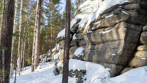 Rock Isetskaya wall next to Mount Motaiha. Long rocky ridge. Iset village, Sverdlovsk region, Ural, Russia. Tourist attractions. Hiking in winter photo