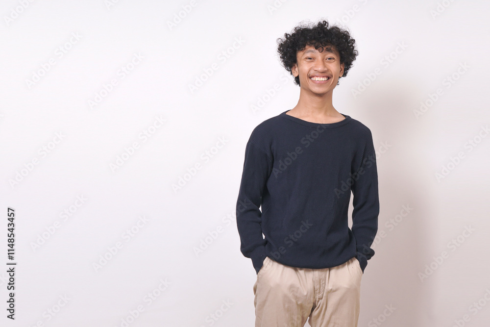 young man smiling in blue sweater standing with arms on pocket , businessman on white background young man smiling in blue sweater standing with arms on pocket , businessman on white background