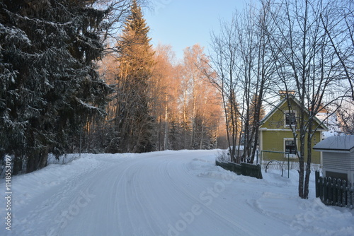 infrastructure, Varkaus, Finland. Beautiful winter streets, alleys with roads, cars, cyclists, sidewalks, green fir trees, birches, trees, covered snow. photo