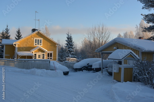 infrastructure, Varkaus, Finland. Beautiful winter streets, alleys with roads, cars, cyclists, sidewalks, green fir trees, birches, trees, covered snow. photo