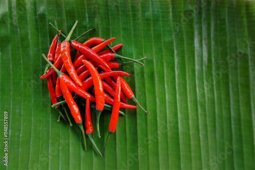 Red chilies placed on banana leaves, top view