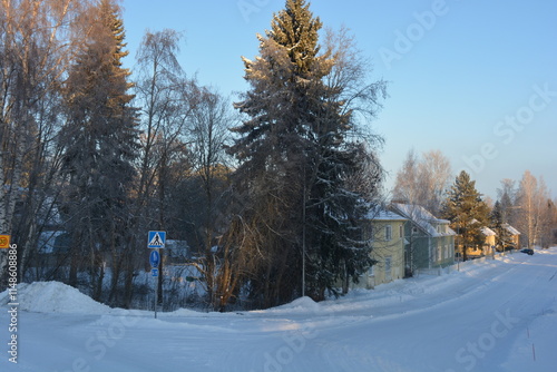 infrastructure, Varkaus, Finland. Beautiful winter streets, alleys with roads, cars, cyclists, sidewalks, green fir trees, birches, trees, covered snow. photo