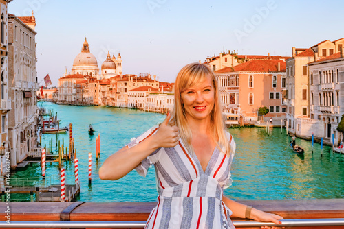 Obraz na płótnie A Beautiful Tourist woman Standing on a Scenic Bridge in Venice During a Stunning Sunset View of Venices Grand Canal w salonie