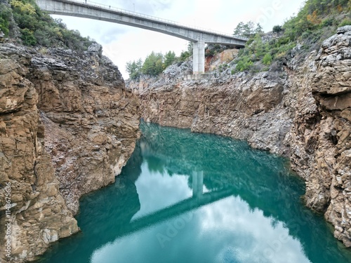 reservoir with emerald water rocky shore photo