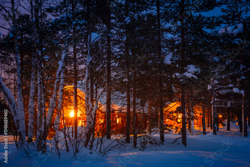 Wooden Cottages in the Night Snowy Forest