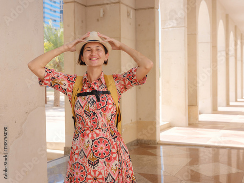 Young woman exploring Qasr Al Hosn Park in Abu Dhabi. Surrounded by lush greenery and historical landmarks, she enjoys the serene atmosphere and Emirati heritage in heart of city. photo