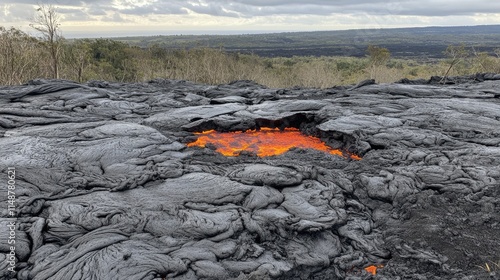 Glowing lava vent in a solidified lava field, volcanic landscape.