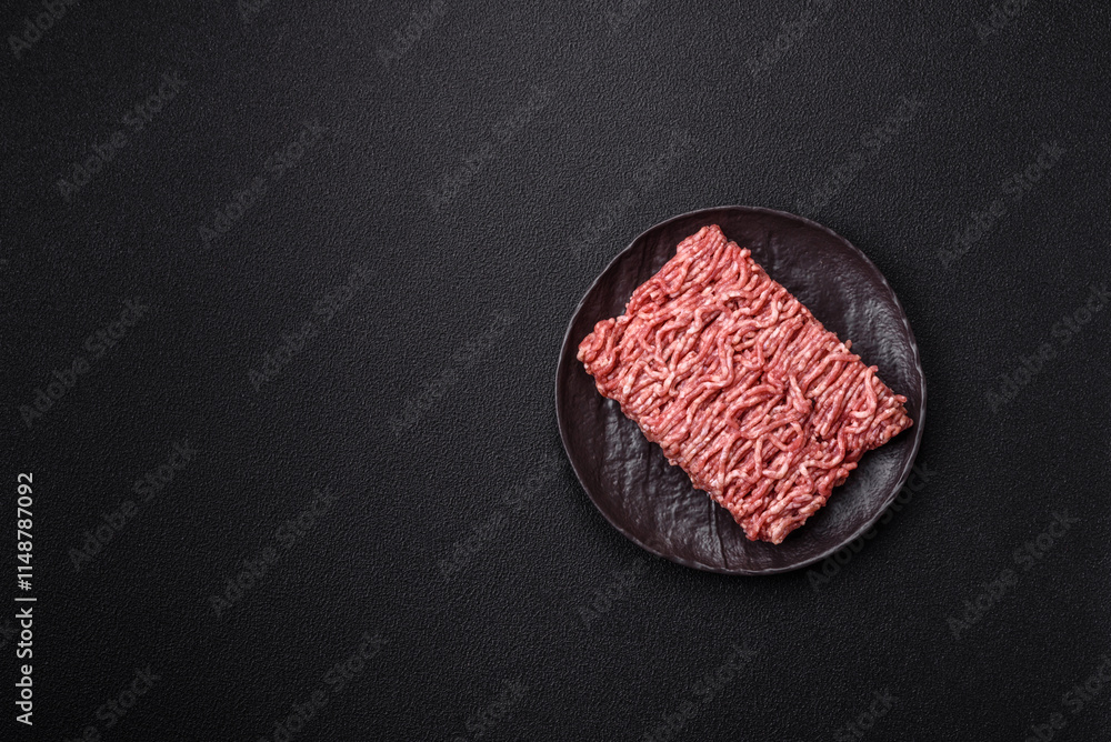 Fresh raw ground minced beef with salt and spices Fresh raw ground minced beef with salt and spices