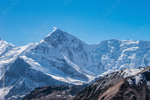 Snow and ice covered mount Gangapurna in winter morning. View from the way to Thorung La. Annapurna circuit trekking, Himalaya mountains, Nepal. photo