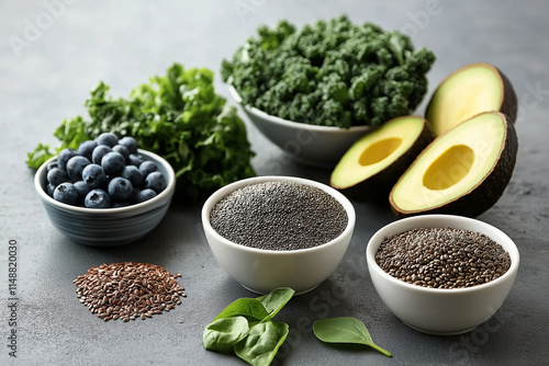 Photo of vibrant fresh fruits, vegetables, and superfoods like avocados, kale, blueberries, and quinoa arranged on a table with a gray background, symbolizing healthy eating photo