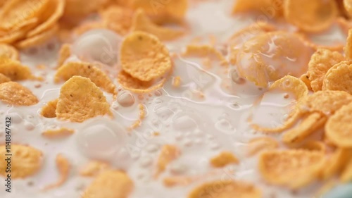 Milk pouring into cereal bowl in slow motion. Crispy cereal for breakfast. Close-up of Crispy cereal for breakfast.