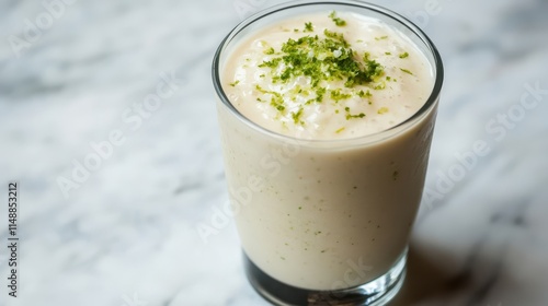 Refreshing Smoothie with Lime Zest on Creamy Surface