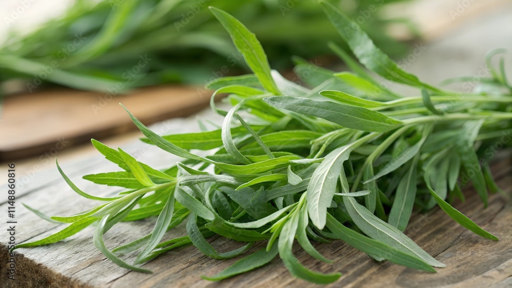 Fresh bunch of tarragon on a wooden surface. Close-up of the narrow green leaves. Fresh bunch of tarragon on a wooden surface. Close-up of the narrow green leaves.