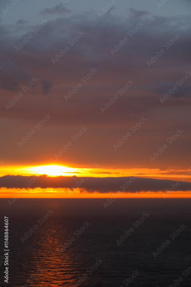 Cloudy sky over the Baltic Sea painted in the colours of the setting sun in Ustronie Morskie, West Pomerania, Poland Cloudy sky over the Baltic Sea painted in the colours of the setting sun in Ustronie Morskie, West Pomerania, Poland
