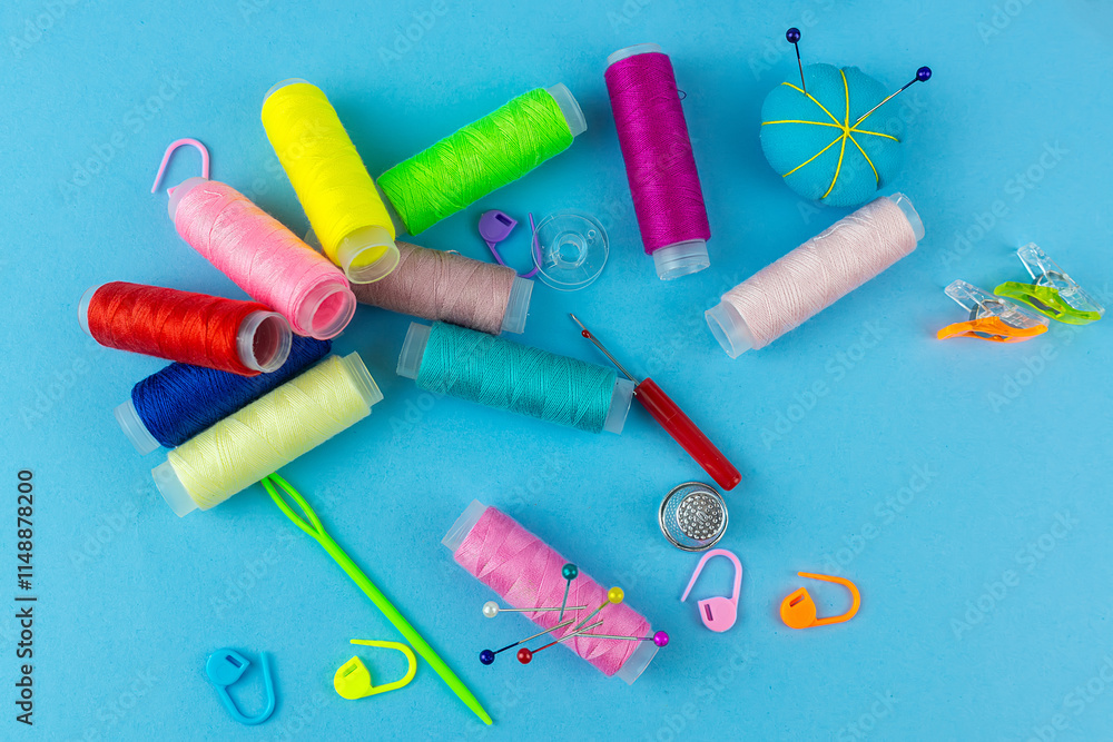 Sewing accessories on a blue bed background. Sewing accessories on a blue bed background.