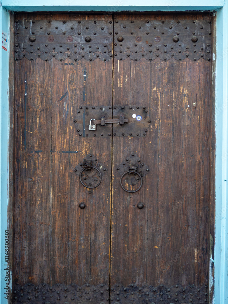 Fototapeta premium Old wooden door with locks and rings. Closed door.