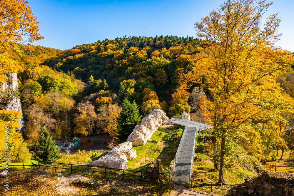 Viewpoint platform in castle park with autumn fall colors of trees in Ojcow National Park, Poland