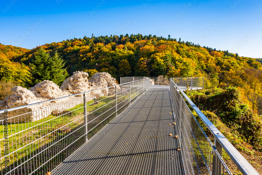 Viewpoint platform in castle park with autumn fall colors of trees in Ojcow National Park, Poland
