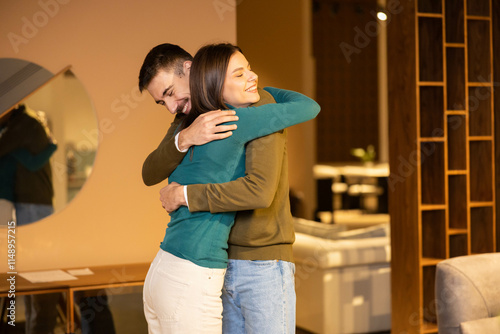 Photos In a warm embrace, the couple signifies agreement at a modern furniture store