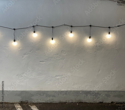 White concrete wall illuminated by lamps photo