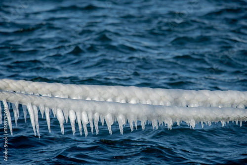 Obraz na płótnie The weather is very cold. Images of frozen ship ropes in the sea. Icicles. w salonie