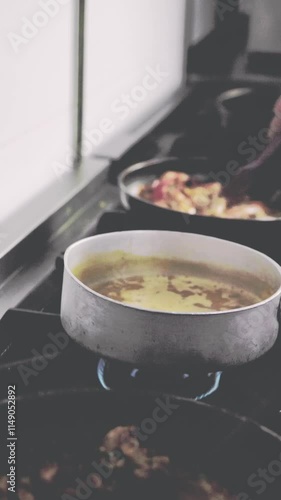Chef cooking Encebollado traditional ecuadorian food in restaurant kitchen