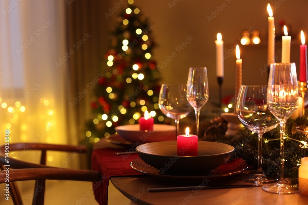 Festive table setting in room decorated for Christmas, closeup. Bokeh effect Festive table setting in room decorated for Christmas, closeup. Bokeh effect